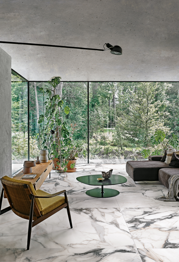 a screened in porch with marble tile flooring and outdoor chairs and a table